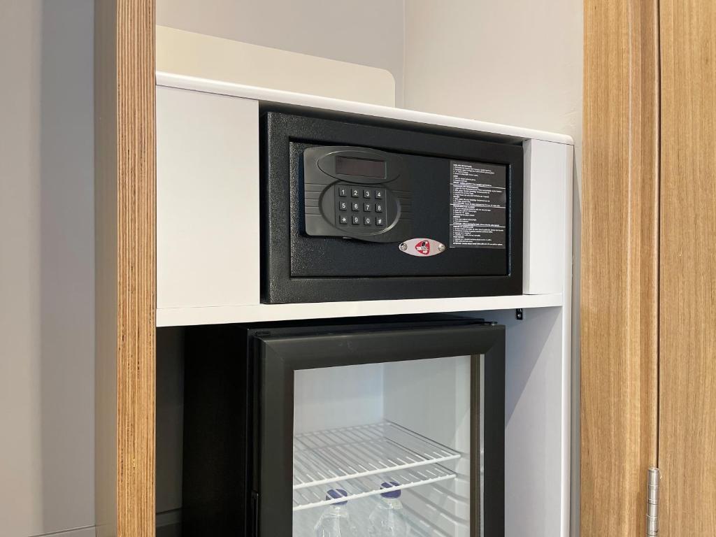 a microwave oven sitting on top of a refrigerator at Holiday Inn Express - Ankara - Airport by IHG in Ankara