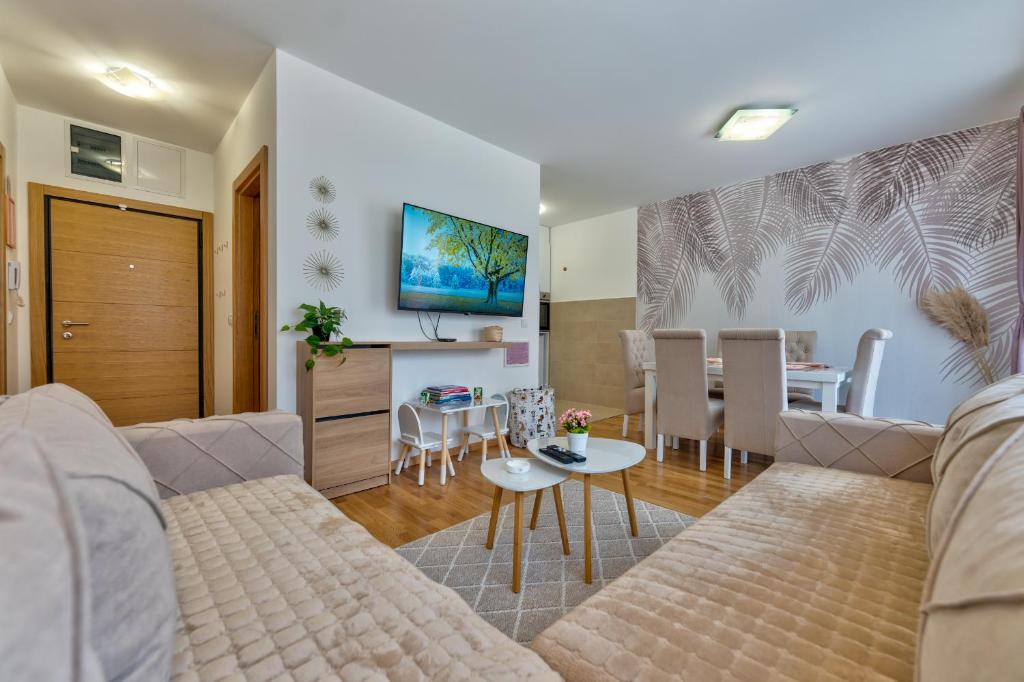 a living room with a couch and a table at Apartment Valt & Spa in Zlatibor