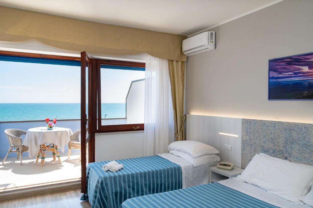 Postel nebo postele na pokoji v ubytování Hotel Galf