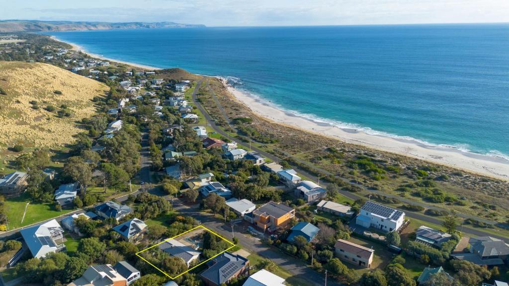 an aerial view of a beach with houses and the ocean at 25 Elizabeth Crescent in Carrickalinga