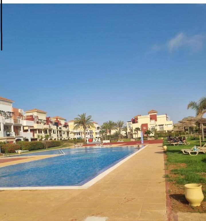 a swimming pool in the middle of a resort at Appartement MARINA AP4 SAIDIA in Saïdia