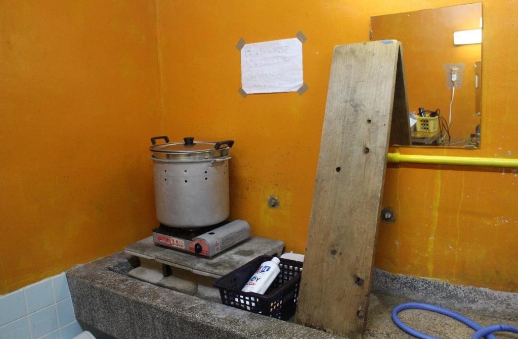 a kitchen with a pot on top of a stove at やどバンブー in Hateruma