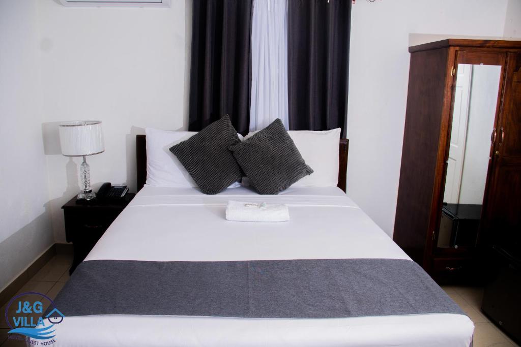 Postel nebo postele na pokoji v ubytování J&G Villa Hotel