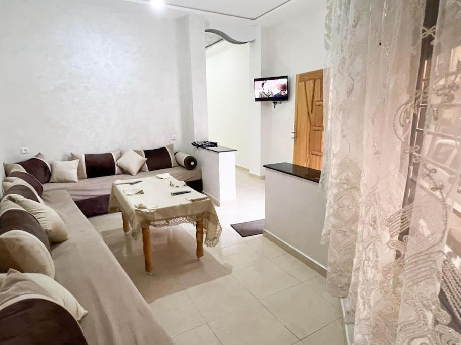 a living room with a couch and a table at Spacious apartment for a comfortable stay in Al Hoceïma