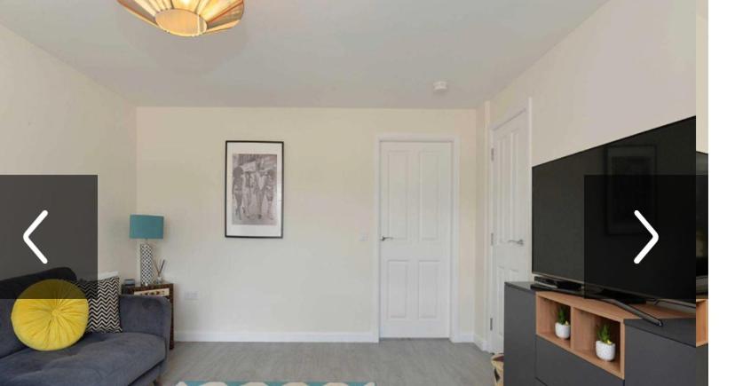 a living room with a couch and a flat screen tv at Edinburgh upper villa end terrace in Edinburgh