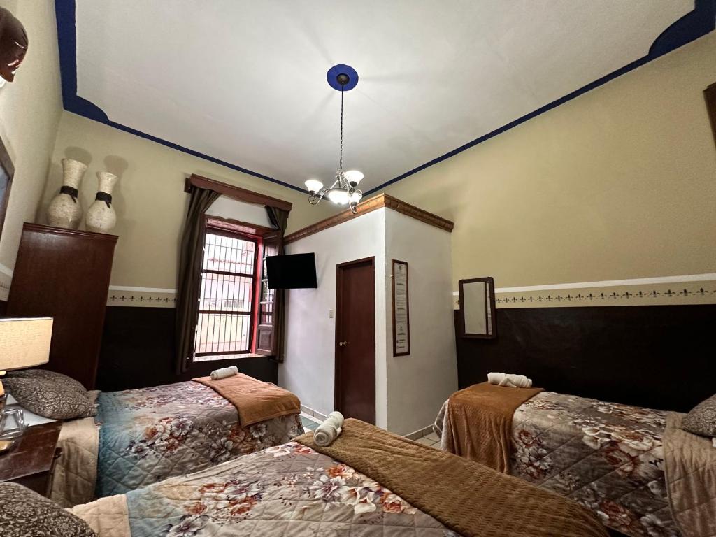 Postel nebo postele na pokoji v ubytování Copa de Oro Hotel Boutique
