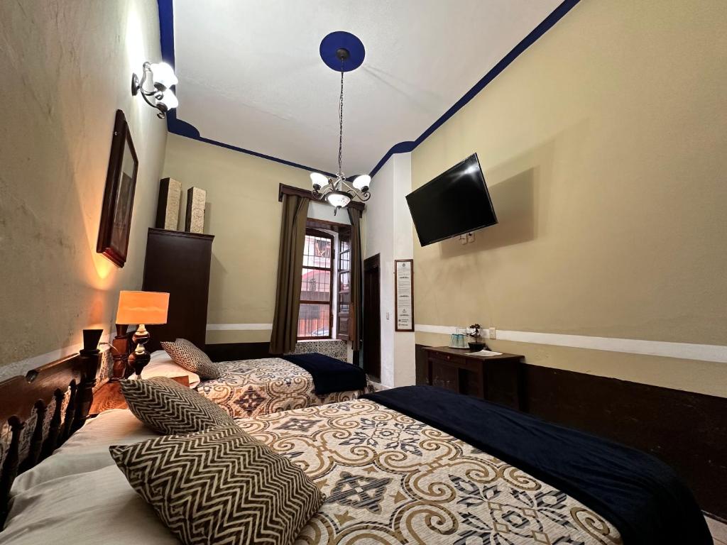 Postel nebo postele na pokoji v ubytování Copa de Oro Hotel Boutique
