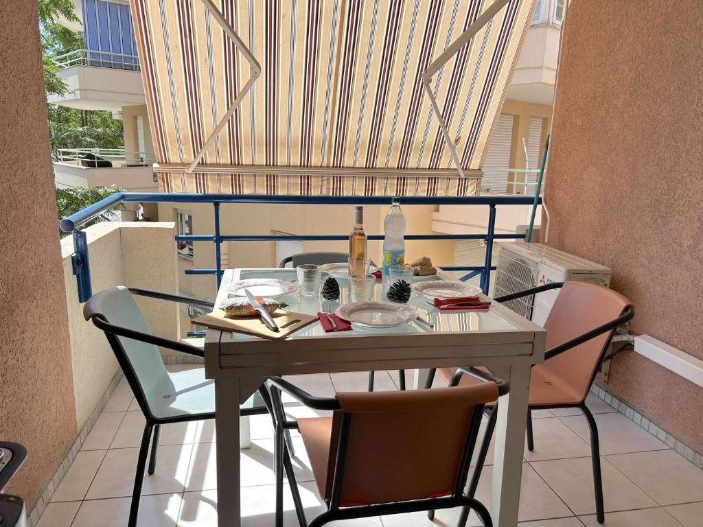 d'un balcon avec une table et des chaises. dans l'établissement Appartement cosy à Port Fréjus: climatisé, proche plage, commerces et garage - 4 couchages - FR-1-226A-176, à Fréjus