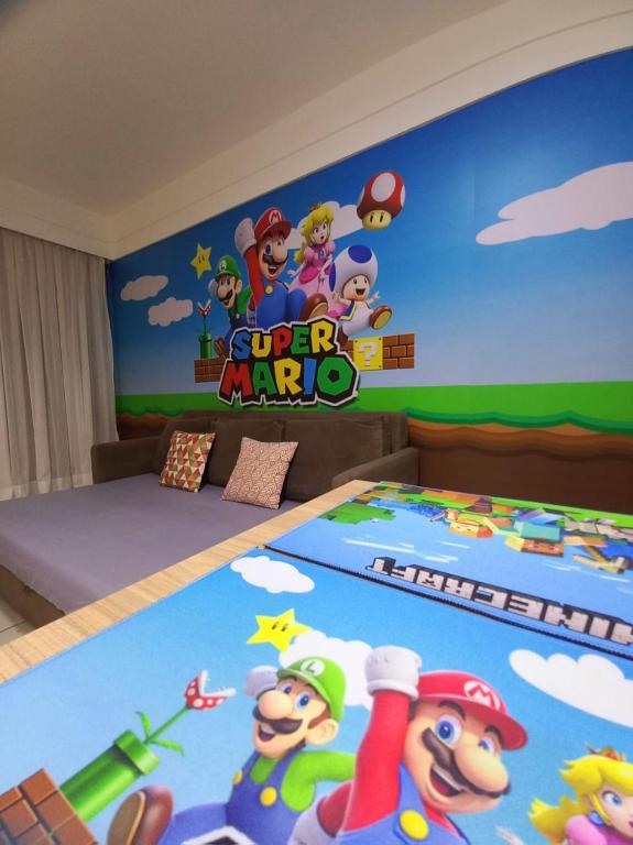 a bedroom with a super mario mural on the wall at Flat Amo Piscina Quartier Aldeia das Águas in Barra do Piraí