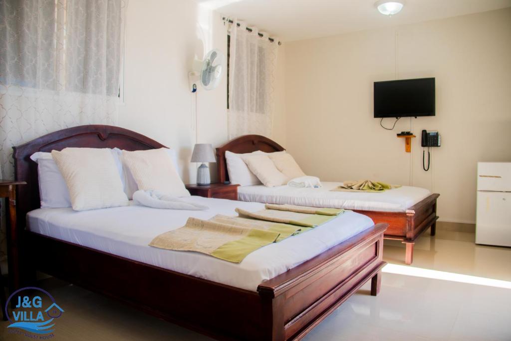 Postel nebo postele na pokoji v ubytování J&G Villa Hotel