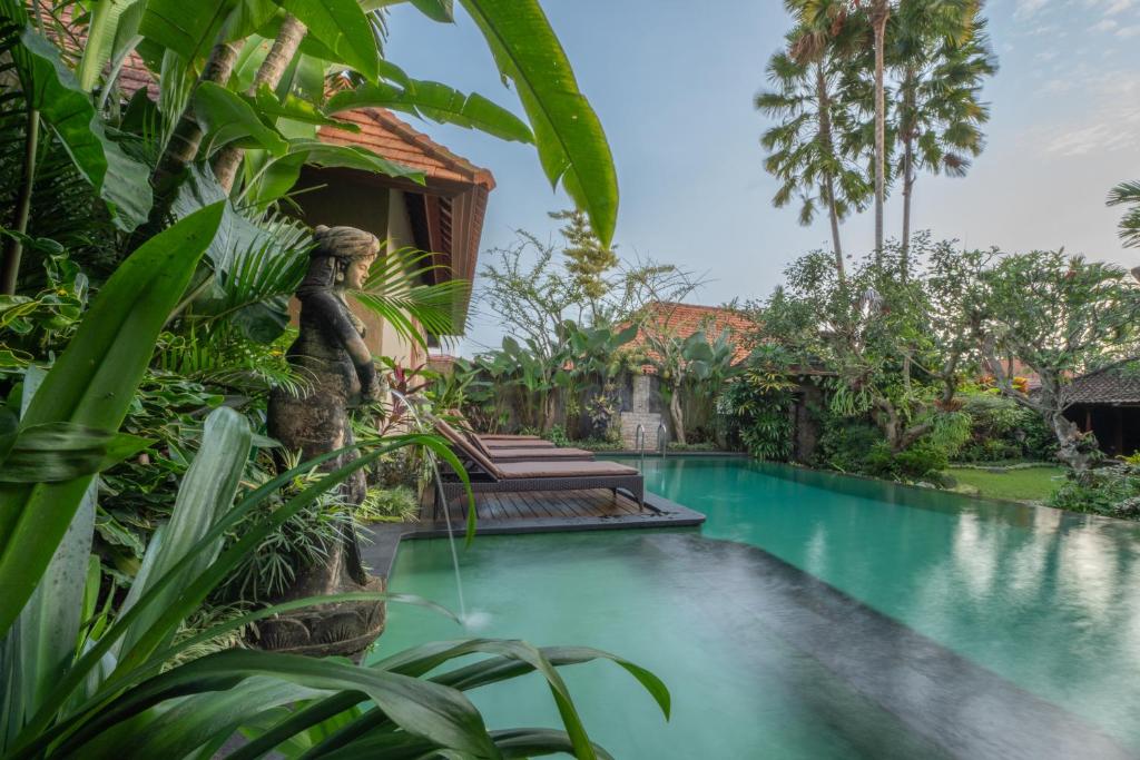 a swimming pool in front of a villa at Villa Unique in Ubud