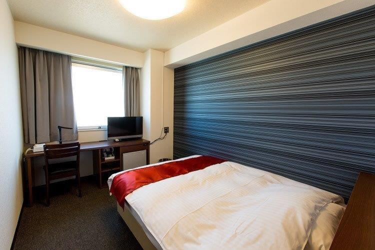 Postel nebo postele na pokoji v ubytování スマイルホテル阿南