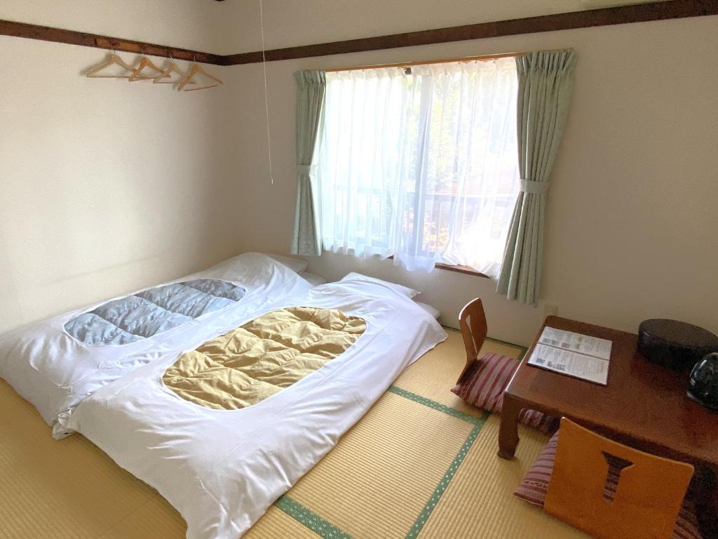Postel nebo postele na pokoji v ubytování Ryokan Seifuso