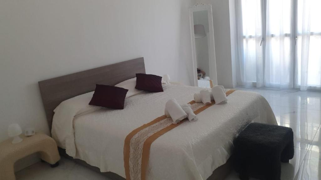 a bedroom with a large white bed with brown pillows at Margherita's House in Turin