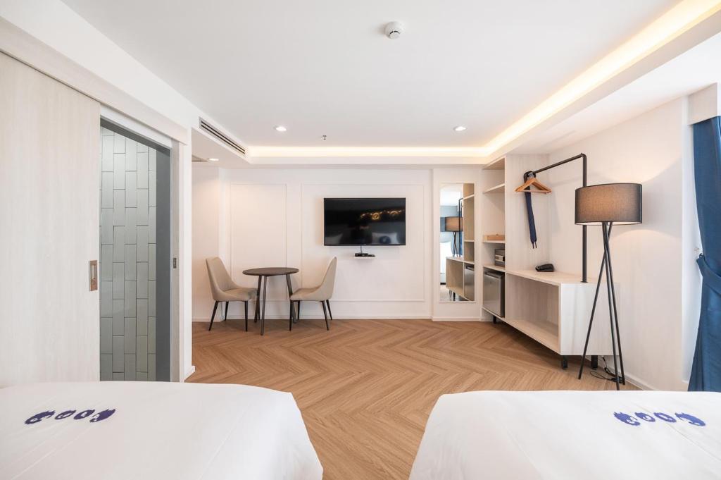 Postel nebo postele na pokoji v ubytování Kokotel Chiang Rai Airport Suites