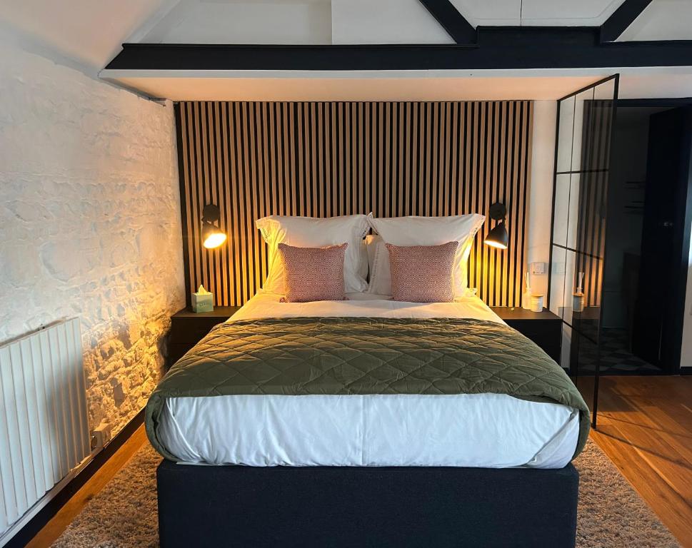 a bedroom with a large bed with pink pillows at The Studio, Arundel in Arundel
