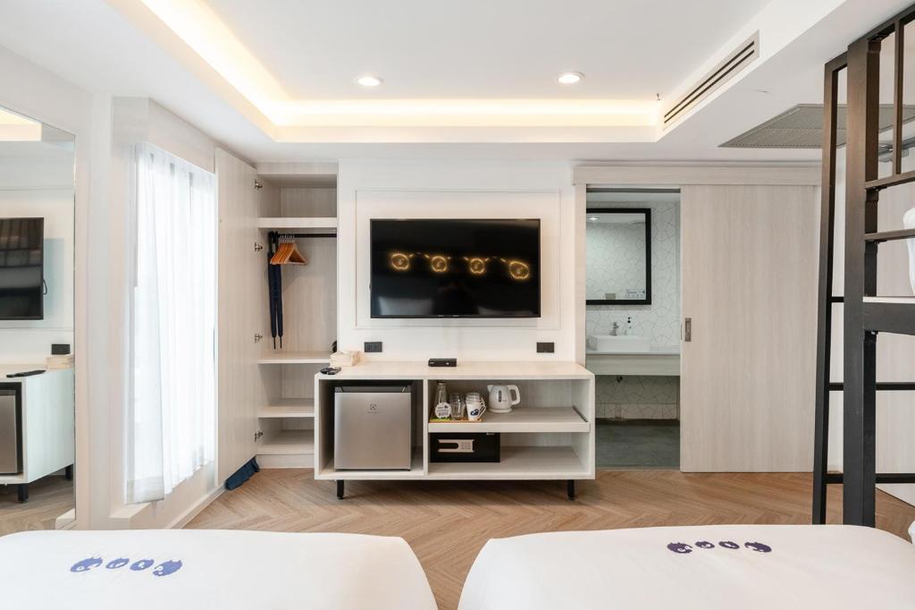 Postel nebo postele na pokoji v ubytování Kokotel Chiang Rai Airport Suites