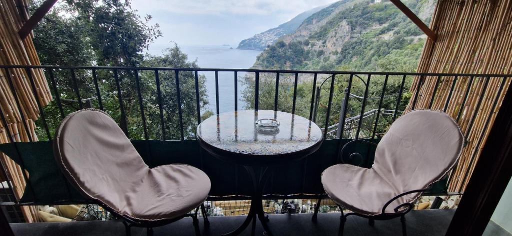a table and chairs on a balcony with a view at Albergo La Conca Azzurra in Conca dei Marini