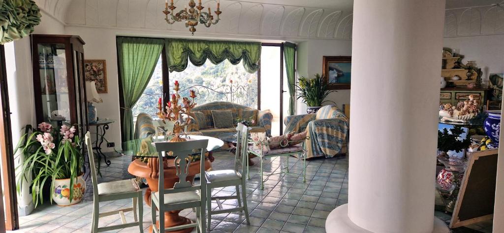 a living room with a table and chairs at Albergo La Conca Azzurra in Conca dei Marini