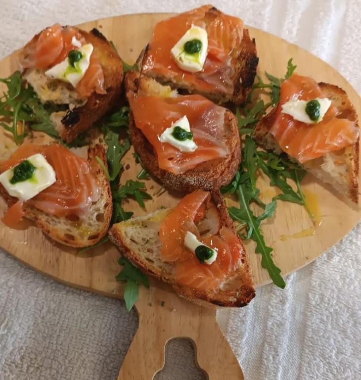 a plate of food with bread with smoked salmon on it at Albergo La Conca Azzurra in Conca dei Marini