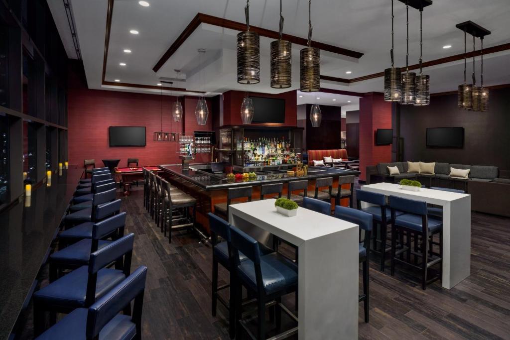 a restaurant with tables and chairs and a bar at Residence Inn by Marriott New York Manhattan/Times Square in New York