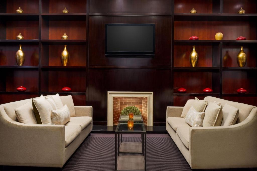 a living room with two couches and a fireplace at Residence Inn by Marriott New York Manhattan/Times Square in New York