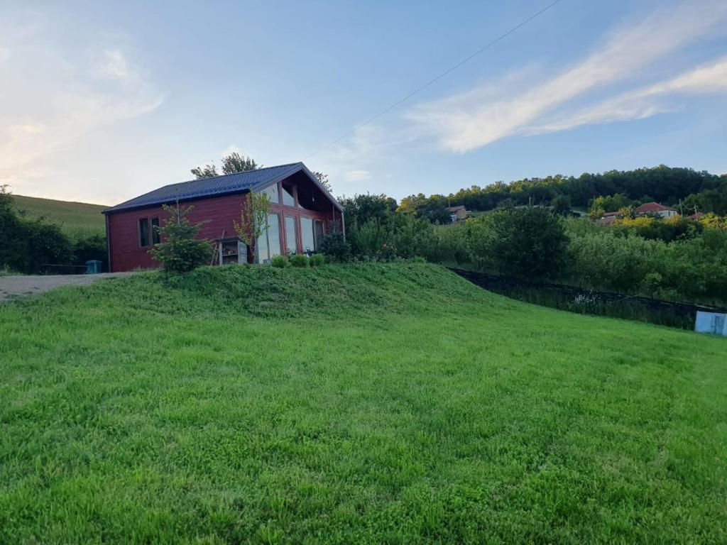 a house on a hill with a green field at Villa Grashtica - Prishtina City in Pristina