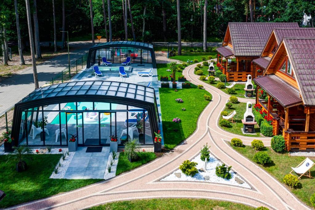 an aerial view of a house with a playground at Bajkowe Domki in Pobierowo