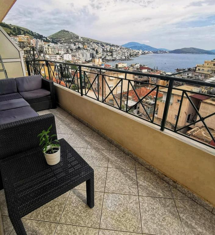 a balcony with a bench and a view of the ocean at Liv Skyline Apartment in Sarandë