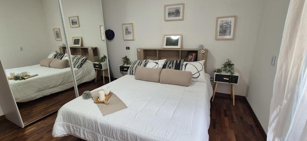 a bedroom with two beds and two shoes on the bed at EUR Fenix Apartment free parking family in Rome
