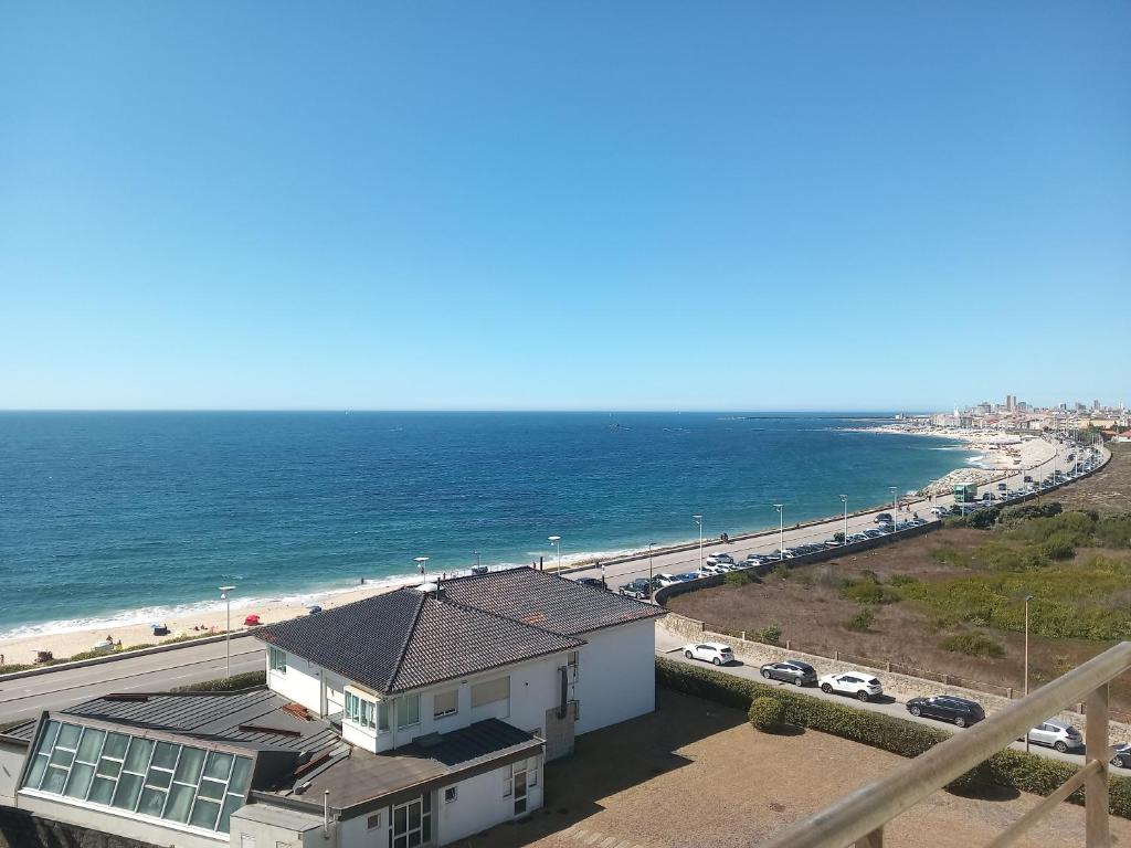 a view of the beach from the balcony of a house at Vila Mar Apartment in Vila do Conde