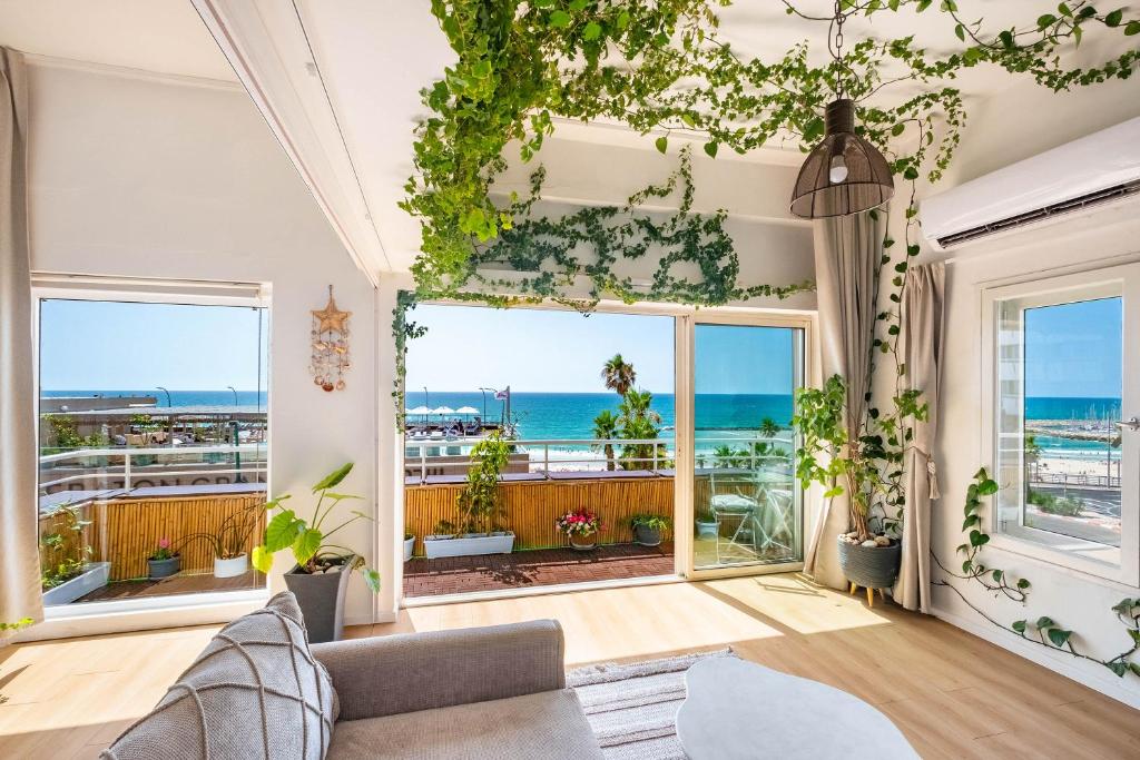 a living room with a view of the ocean at Luxury Apartment - Gordon Beach View 124 in Tel Aviv