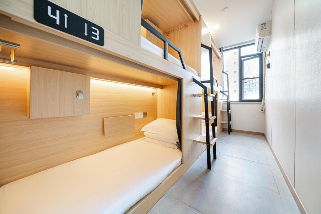 a small room with bunk beds in it at Denpa Inn - The Bund East Nanjing Road in Shanghai