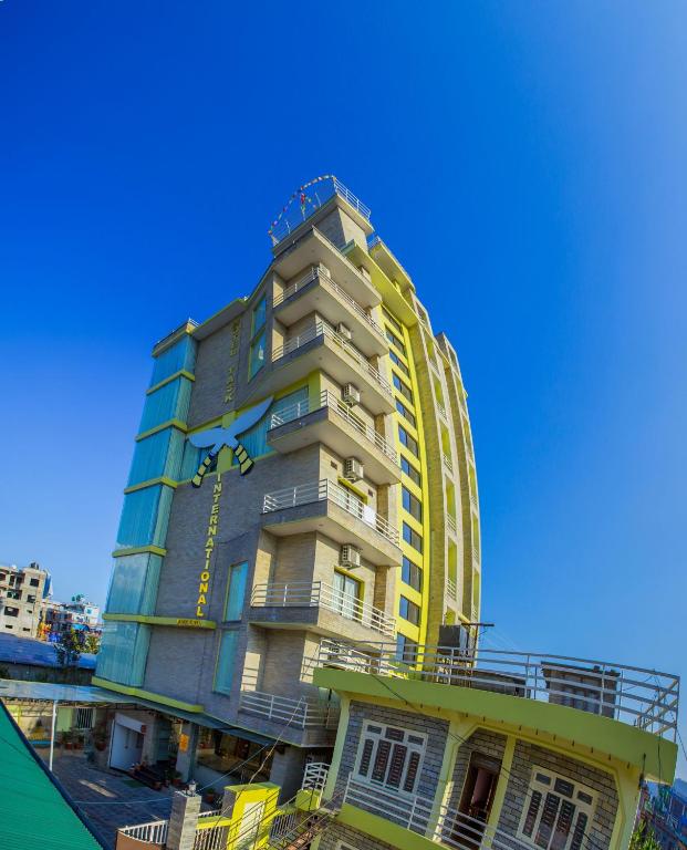 un condominio alto con un giallo di Hotel Task International a Pokhara