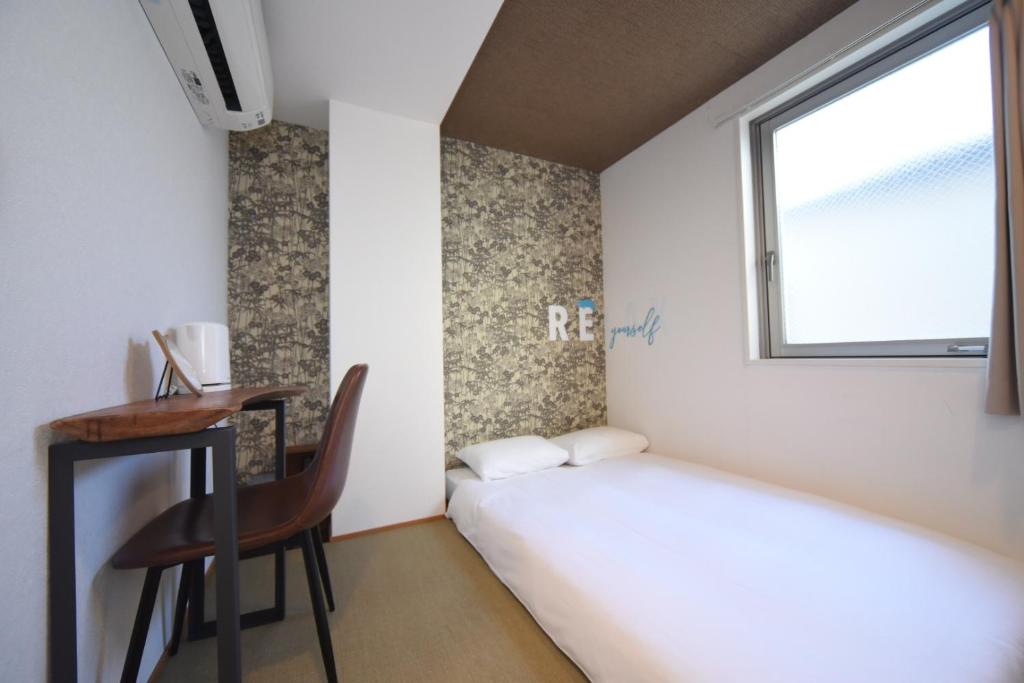 Postel nebo postele na pokoji v ubytování HOTEL WAN OSAKA EBISU