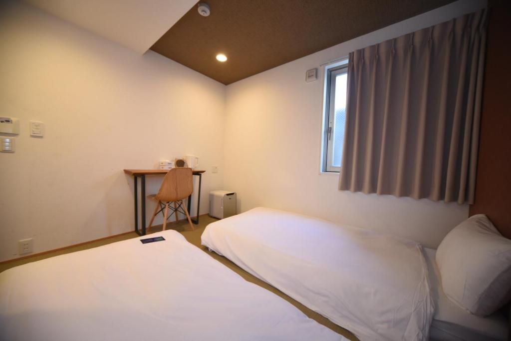 Postel nebo postele na pokoji v ubytování HOTEL WAN OSAKA EBISU