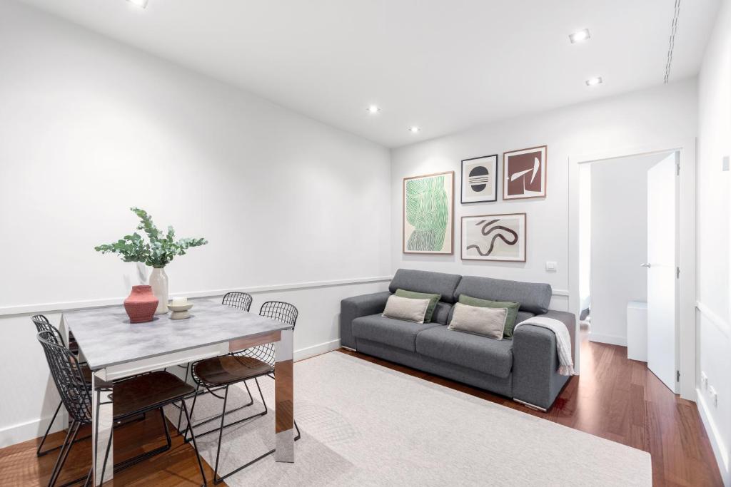 a living room with a couch and a table at Aspasios Paseo de Gracia Apartments in Barcelona