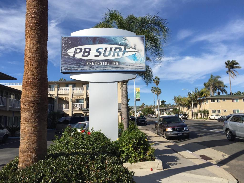 a sign for a resort on a street at PB Surf Beachside Inn in San Diego