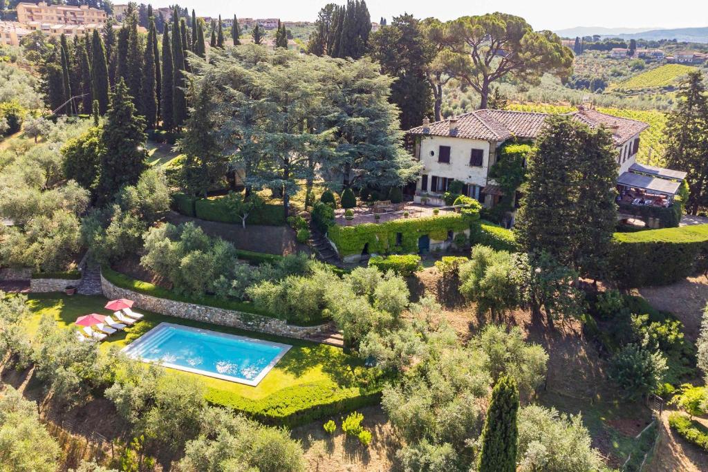 an aerial view of a house with a pool in a garden at Villa D'Agnola by Mmega in San Casciano in Val di Pesa