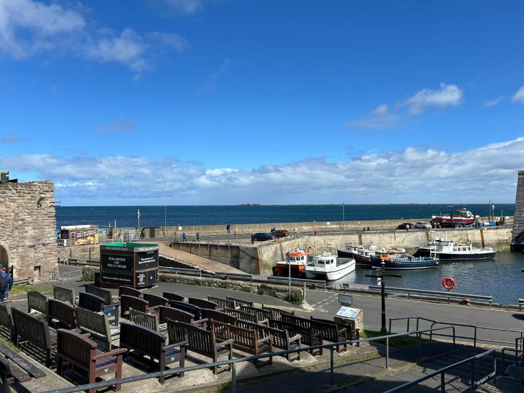 a group of boats docked in a harbor at Chandlers BnB in Seahouses