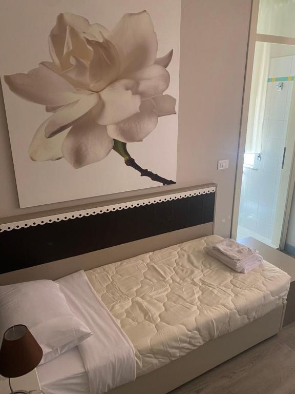 Postel nebo postele na pokoji v ubytování Albergo Leon D'Oro
