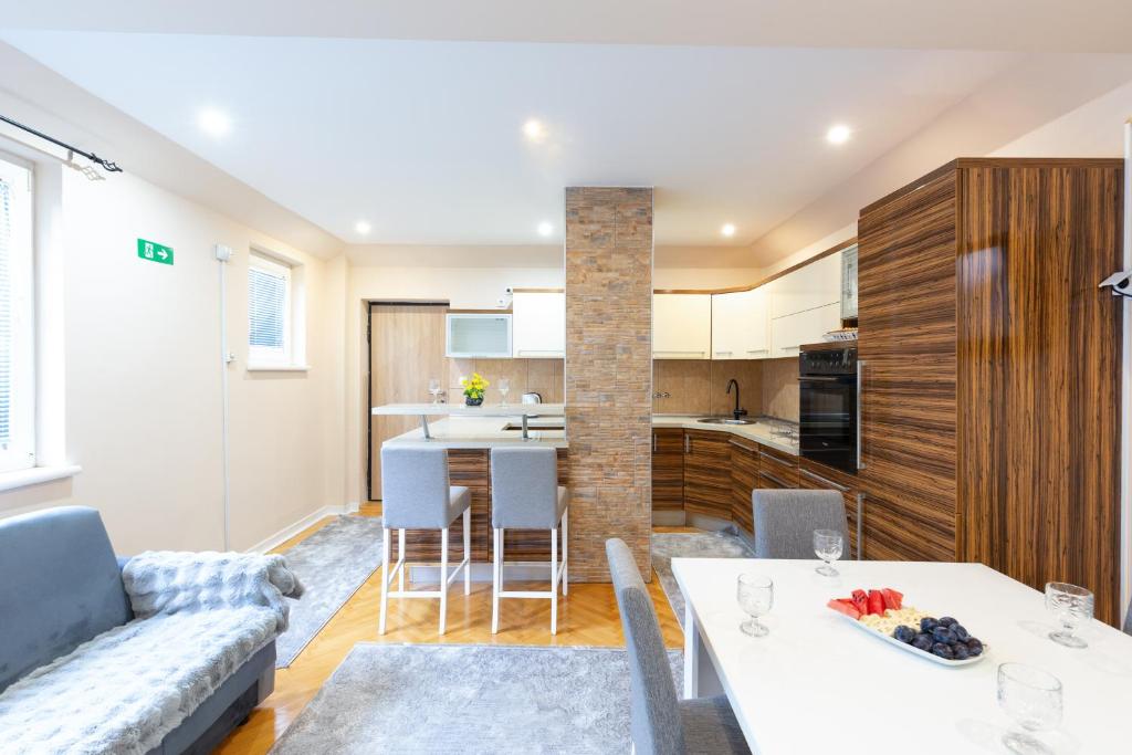 a kitchen and living room with a couch and a table at Evergreen Apartments in Visoko
