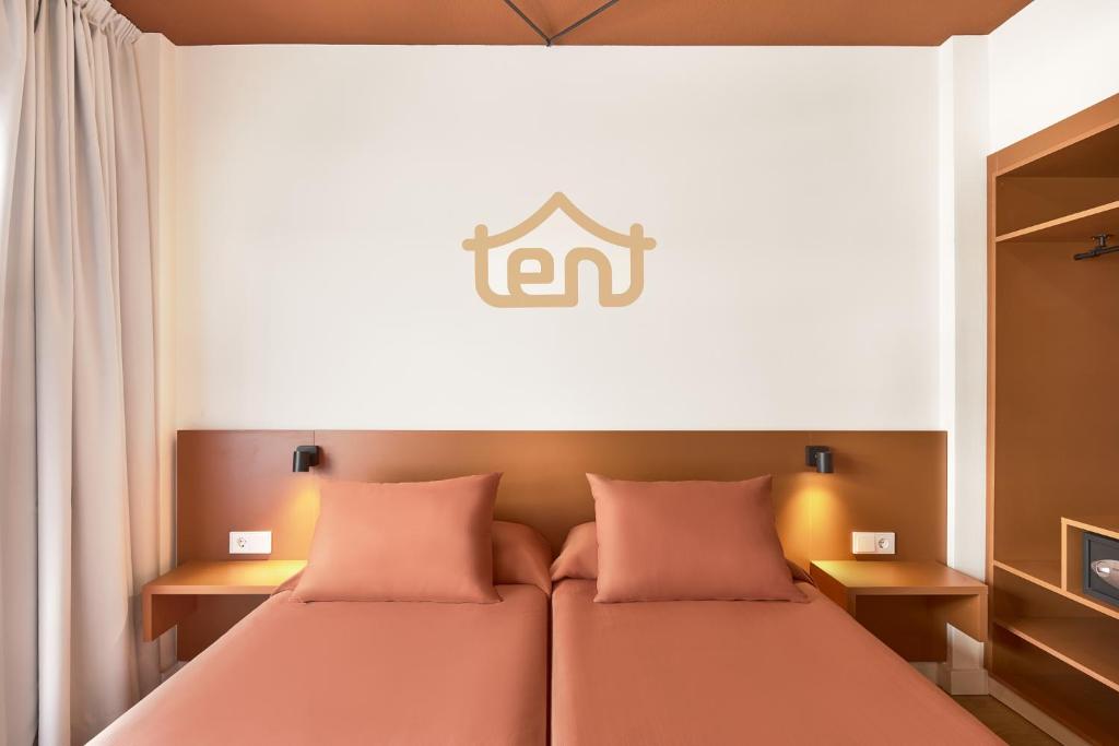 a hotel room with two beds with pink pillows at tent Bahia de Palma in El Arenal
