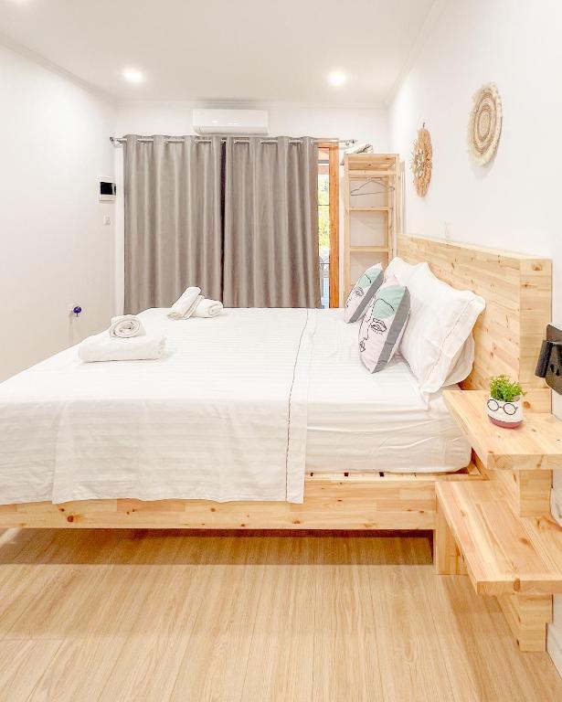 a bedroom with a large white bed with pillows at Vraxlida Living in Himare