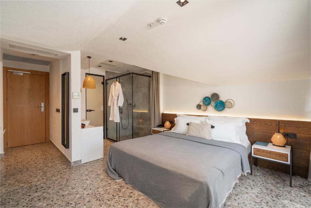 a bedroom with a large bed and a shower at Ölüdeniz Blu Luxury Unique Hotel - Adults-Only in Oludeniz