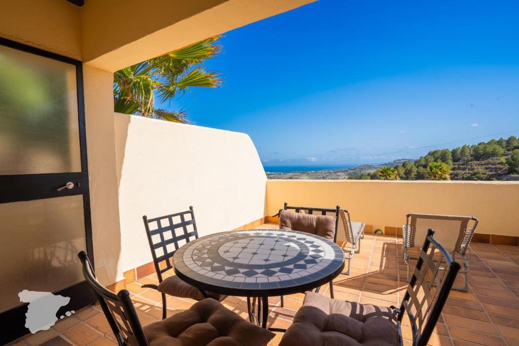 a patio with a table and chairs on a balcony at Casa Horizonte in Moraira
