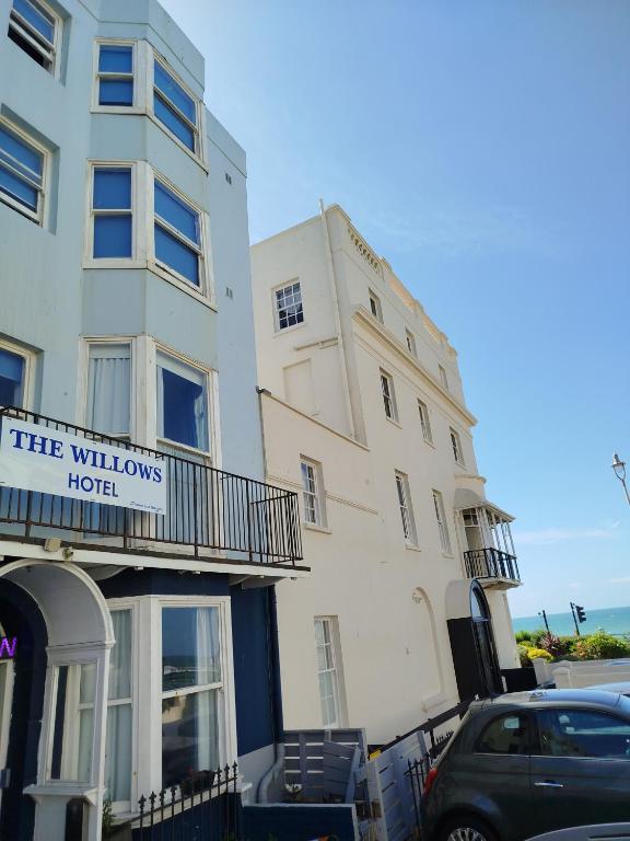 a tall white building with a hotel sign on it at The Willows in Brighton & Hove