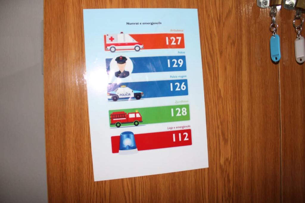 a sign hanging on a door with a picture of trucks at Crew Hostel Tirana in Tirana