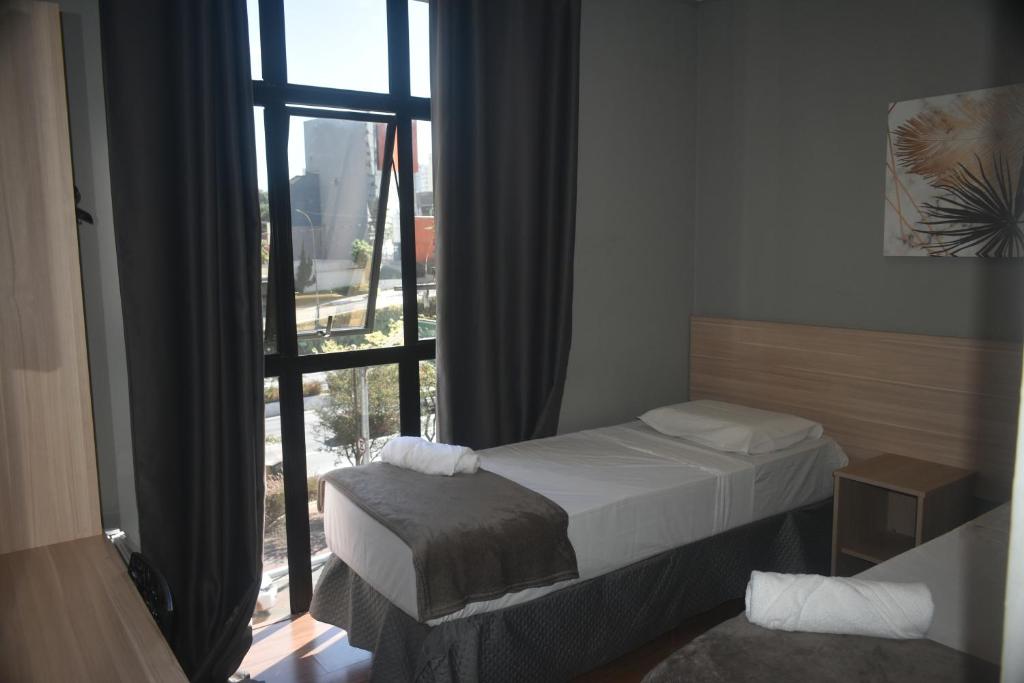 Letto o letti in una camera di Unity Hotel - Vila Mariana SP