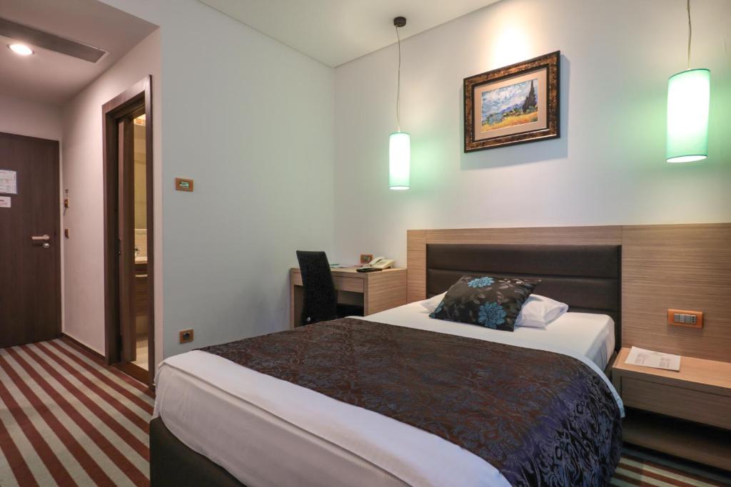 Postel nebo postele na pokoji v ubytování Hotel Nartel